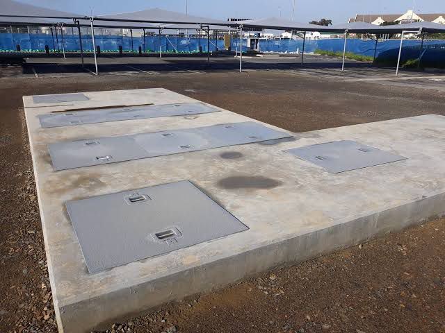 Concrete slab fitted with manhole covers