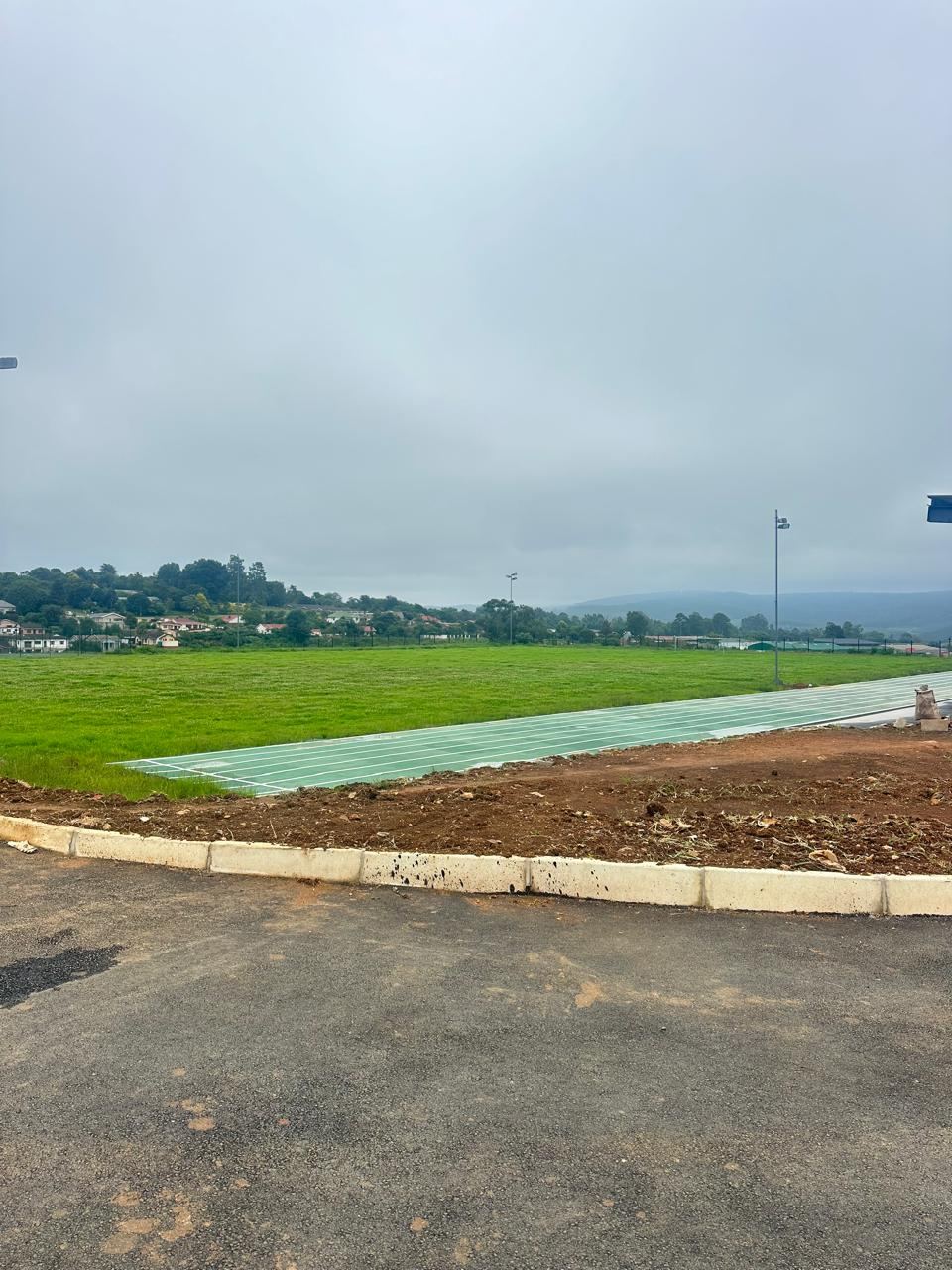 Sports field and track edge with concrete kerb